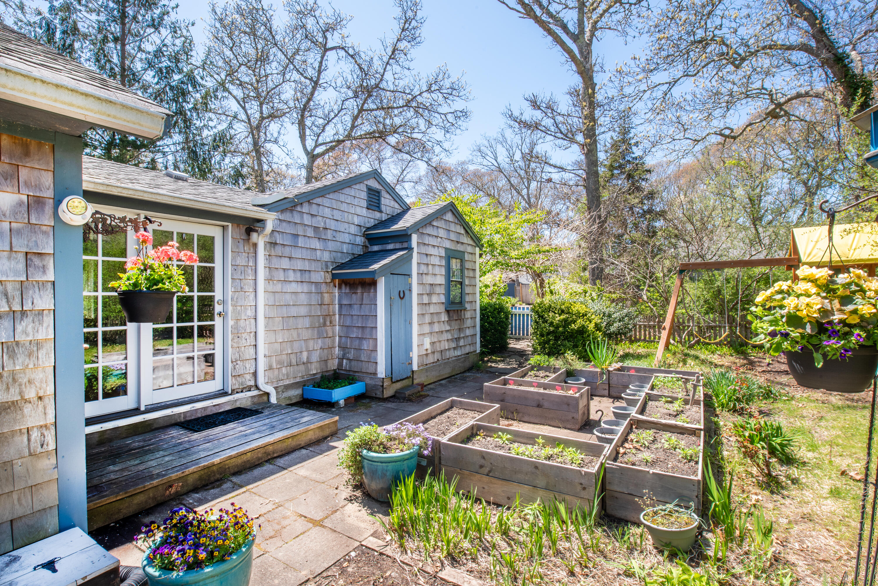 35 Old County Road, Unit 1 Eastham, MA 02642 - Photo 25 of 30 a view of a house with backyard sitting area and garden
