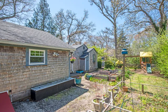 a view of a chairs and table in backyard