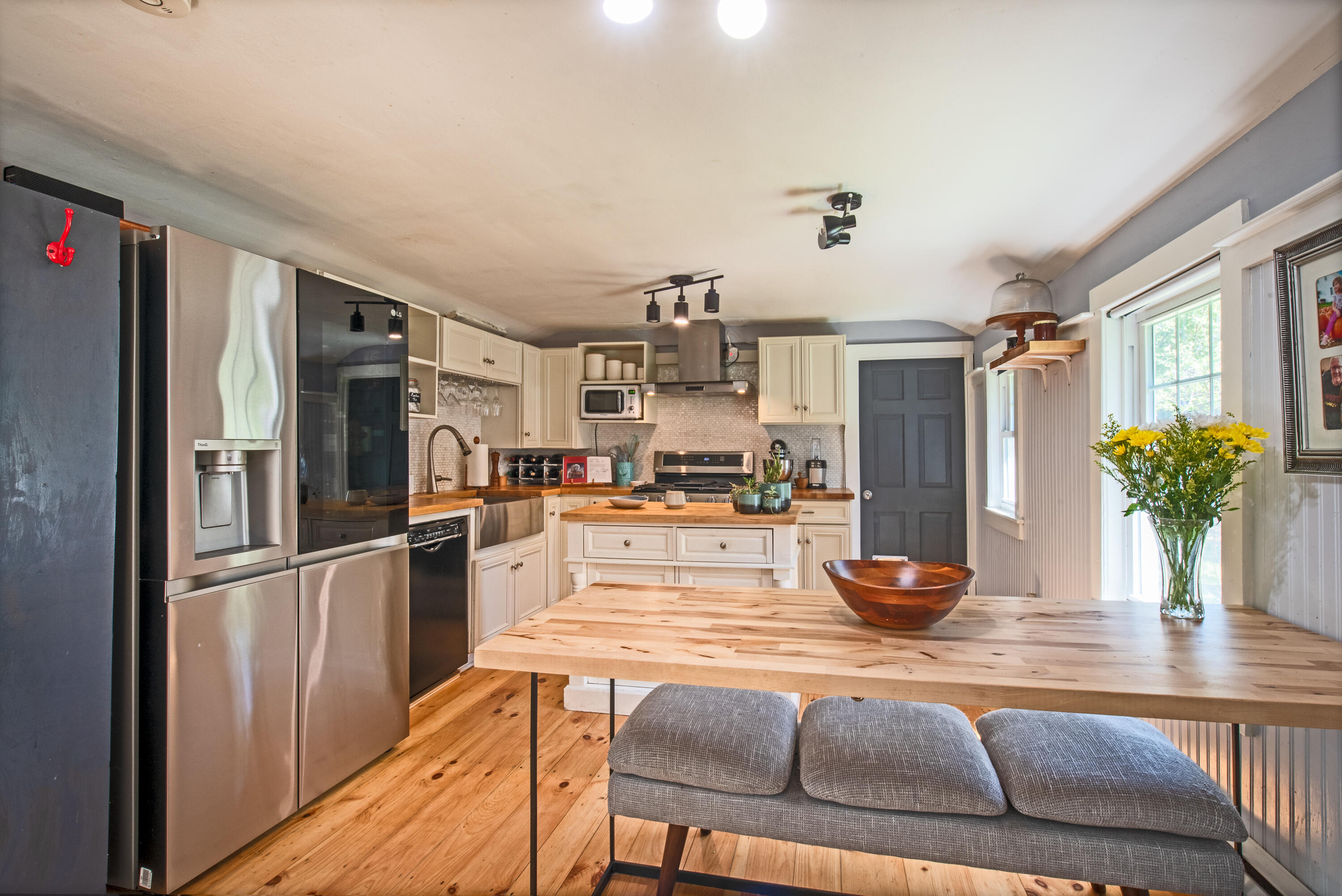 35 Old County Road, Unit 1 Eastham, MA 02642 - Photo 5 of 30 a kitchen with stainless steel appliances kitchen island granite countertop a refrigerator a stove and a sink with wooden floor