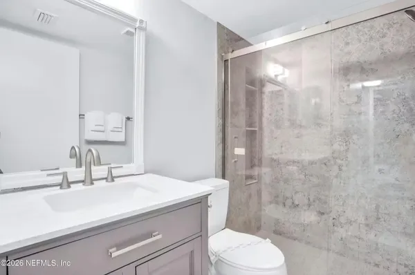 a bathroom with a sink toilet and shower