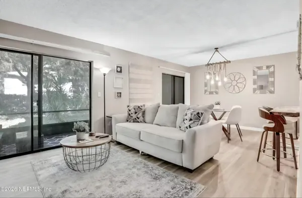 a living room with furniture and a large window