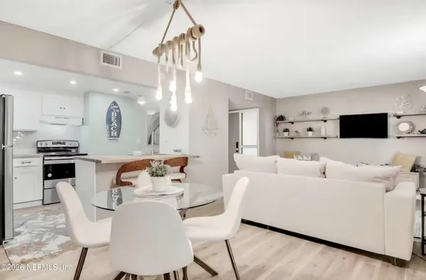 a living room with furniture and kitchen view