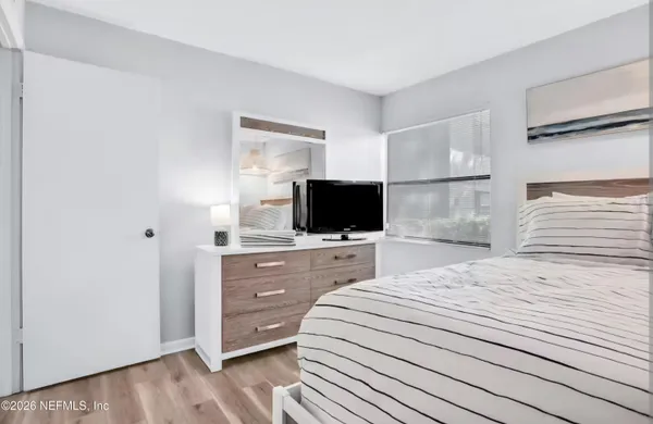 a bedroom with a bed and a television