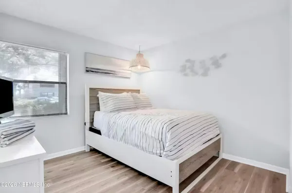 a bed sitting in a bedroom next to a window