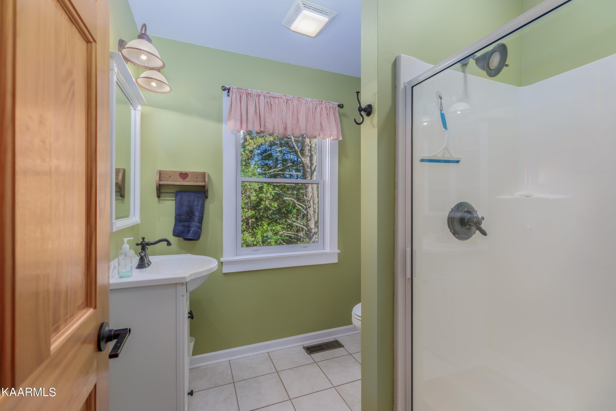 1524 Sandy Ridge Road Dandridge, TN 37725 - Photo 35 of 42 a bathroom with a sink vanity mirror and shower