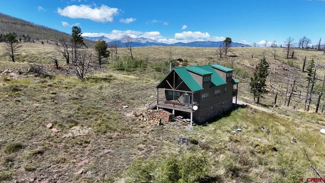 a wooden bench sitting in the middle of a field