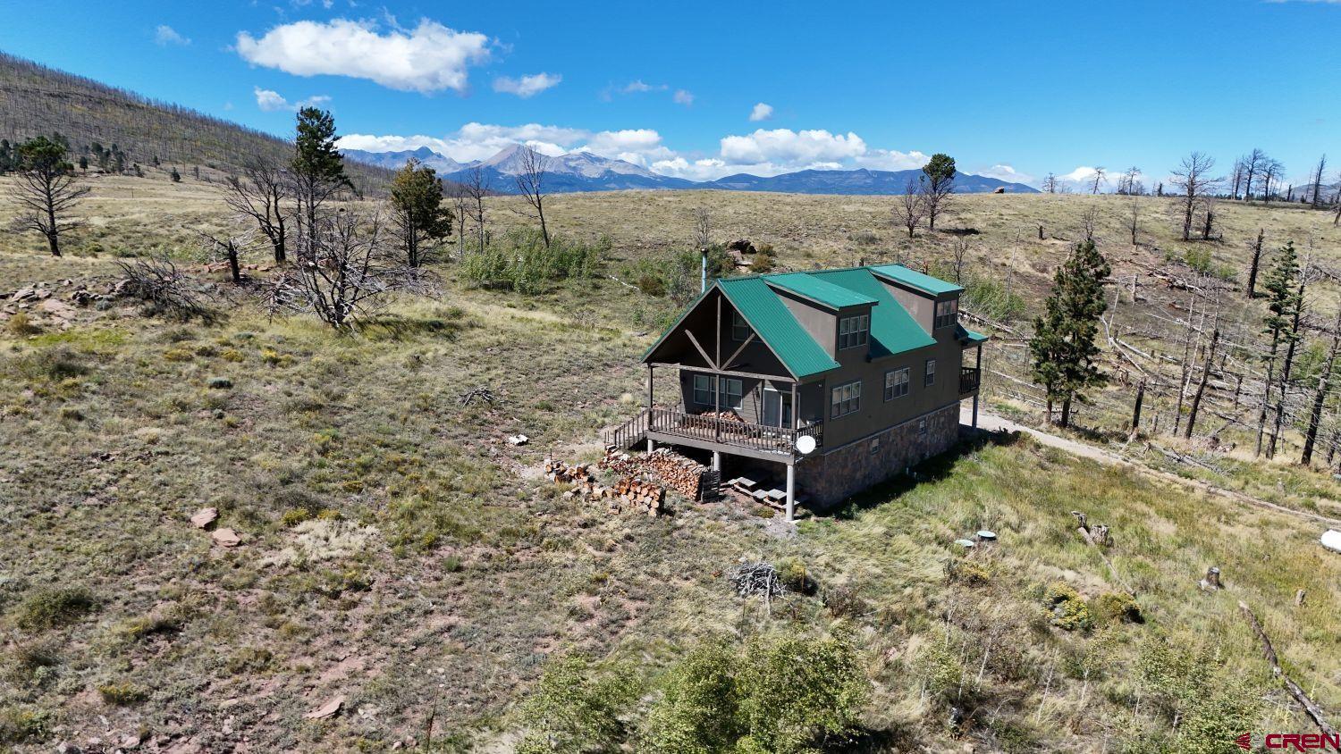 a wooden bench sitting in the middle of a field