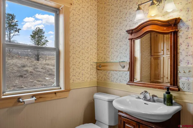 a bathroom with a sink a mirror and a window