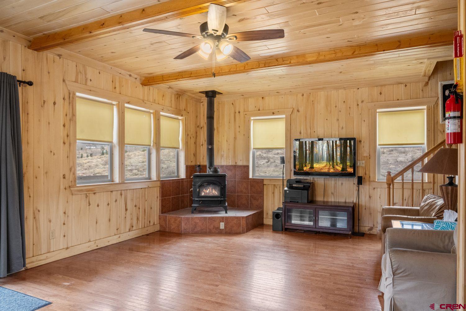 645 Emery Loop Fort Garland, CO 81133 - Photo 18 of 44 a view of a livingroom with furniture a fireplace and wooden floor