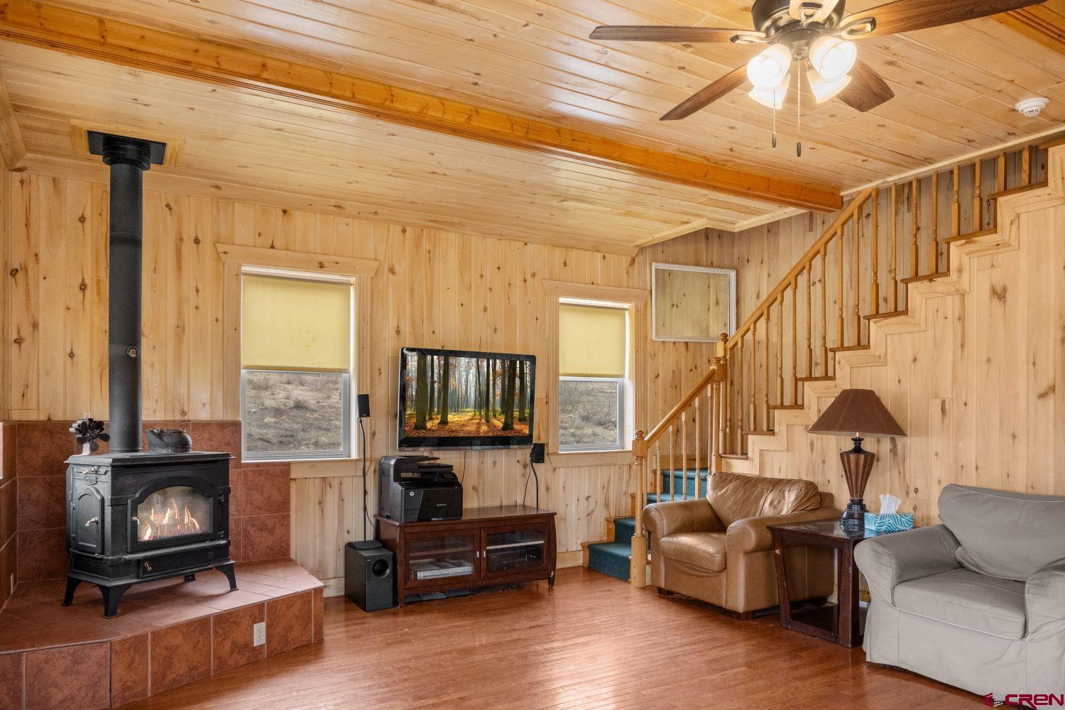 645 Emery Loop Fort Garland, CO 81133 - Photo 19 of 44 a living room with furniture and a flat screen tv