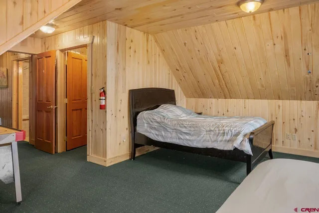 a bedroom with a bed and a table chair