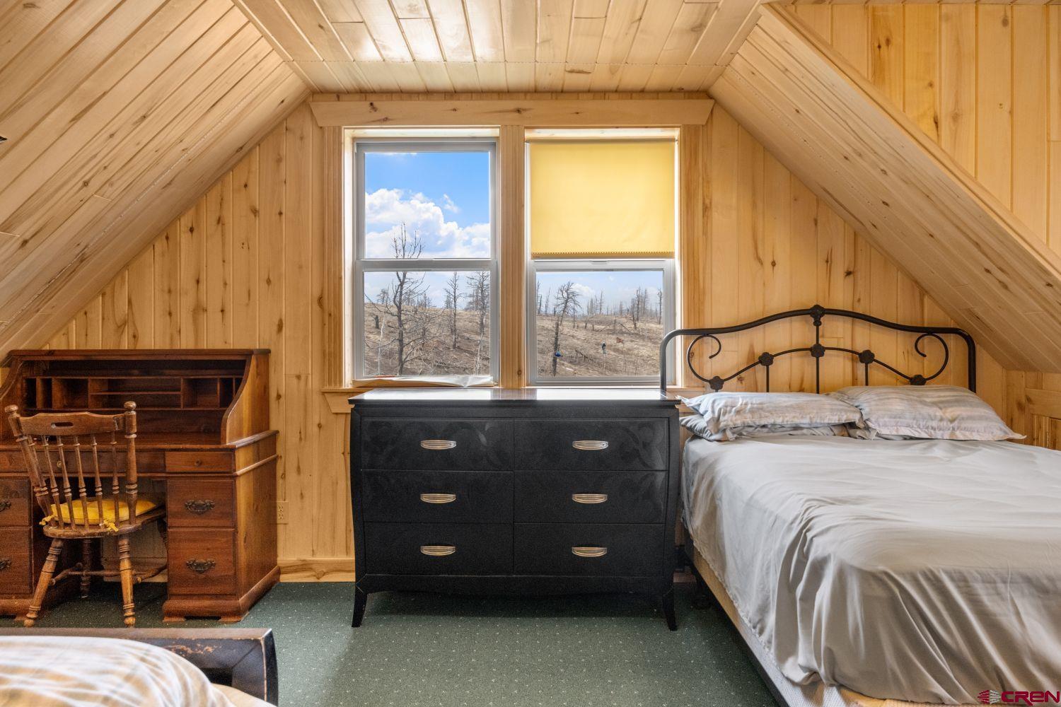645 Emery Loop Fort Garland, CO 81133 - Photo 23 of 44 a bedroom with a bed and a window
