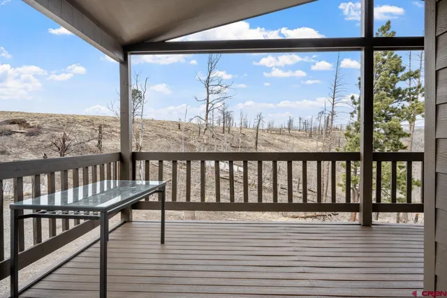 a view of a balcony with wooden floor
