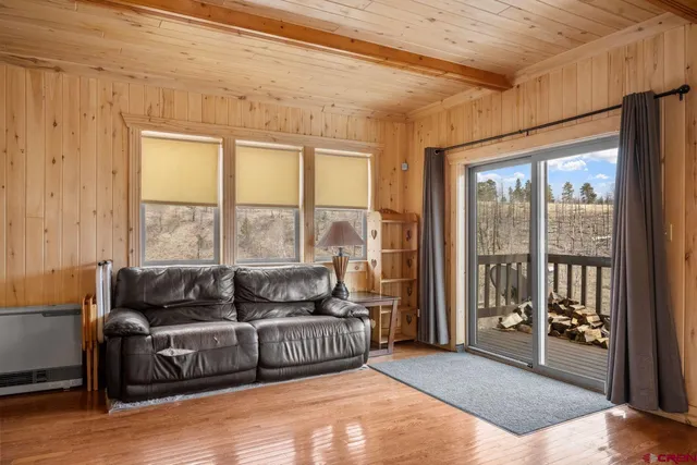 a living room with furniture and a floor to ceiling window