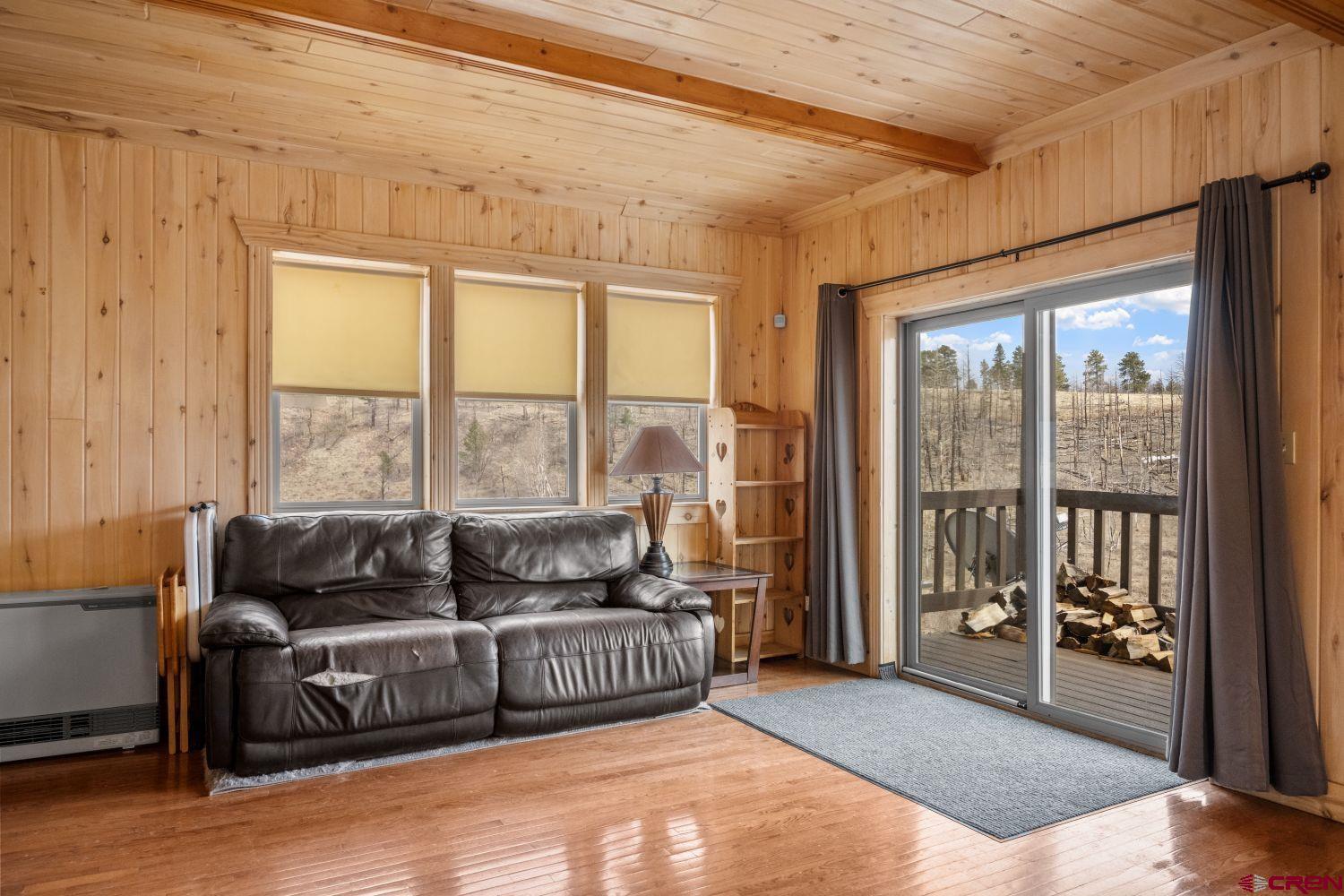 645 Emery Loop Fort Garland, CO 81133 - Photo 10 of 44 a living room with furniture and a floor to ceiling window