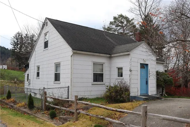 a view of house with backyard