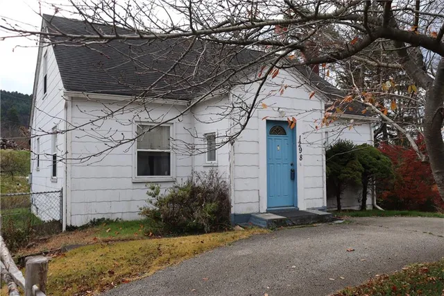 a house with a tree in front of it