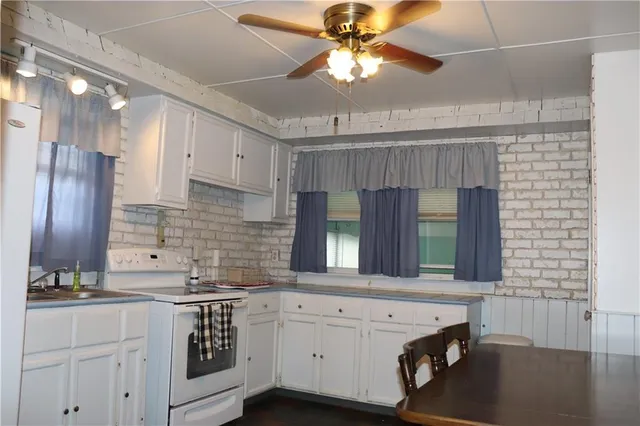 a kitchen with a sink cabinets and window