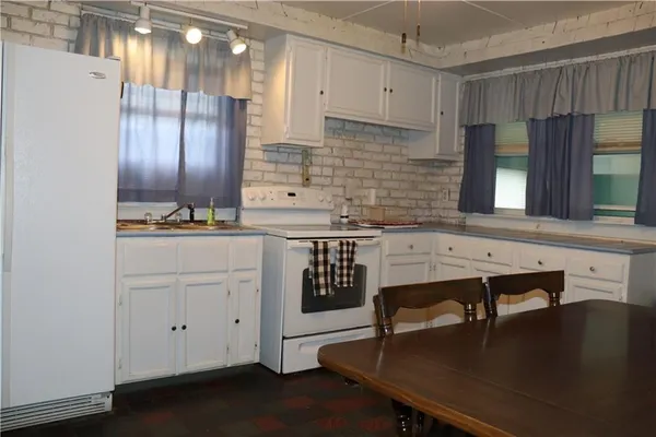 a kitchen with a sink cabinets and window