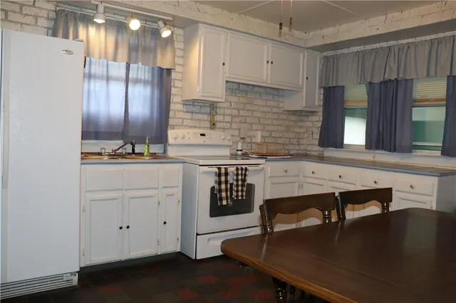 a kitchen with a sink cabinets and window