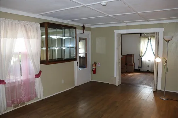 a view of a room with wooden floor