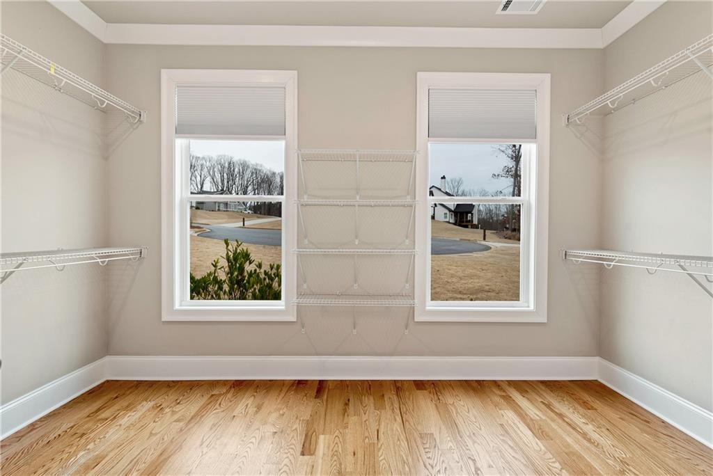 6140 Crescent Moon Ridge Cumming, GA 30041 - Photo 20 of 54 a view of an empty room with wooden floor and a window