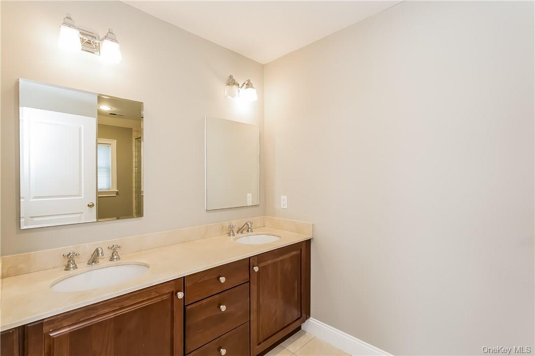 20 Walker Avenue Rye, NY 10580 - Photo 11 of 25 a bathroom with a sink and a mirror