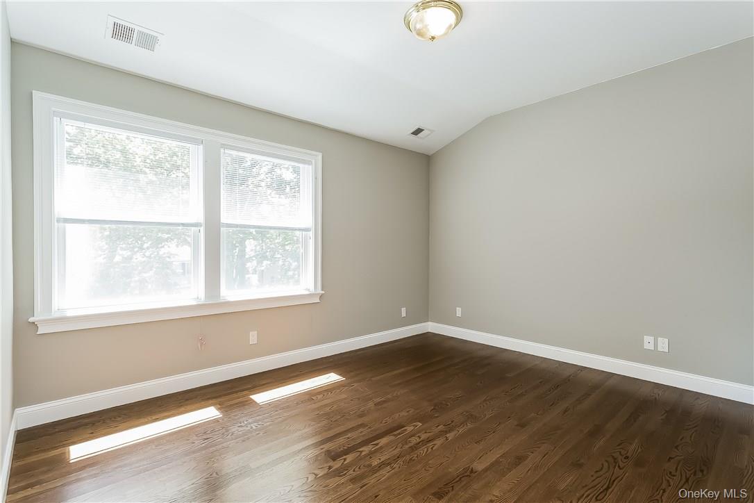 20 Walker Avenue Rye, NY 10580 - Photo 14 of 25 an empty room with wooden floor and windows