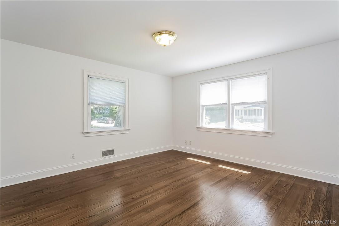 20 Walker Avenue Rye, NY 10580 - Photo 6 of 25 an empty room with wooden floor and windows