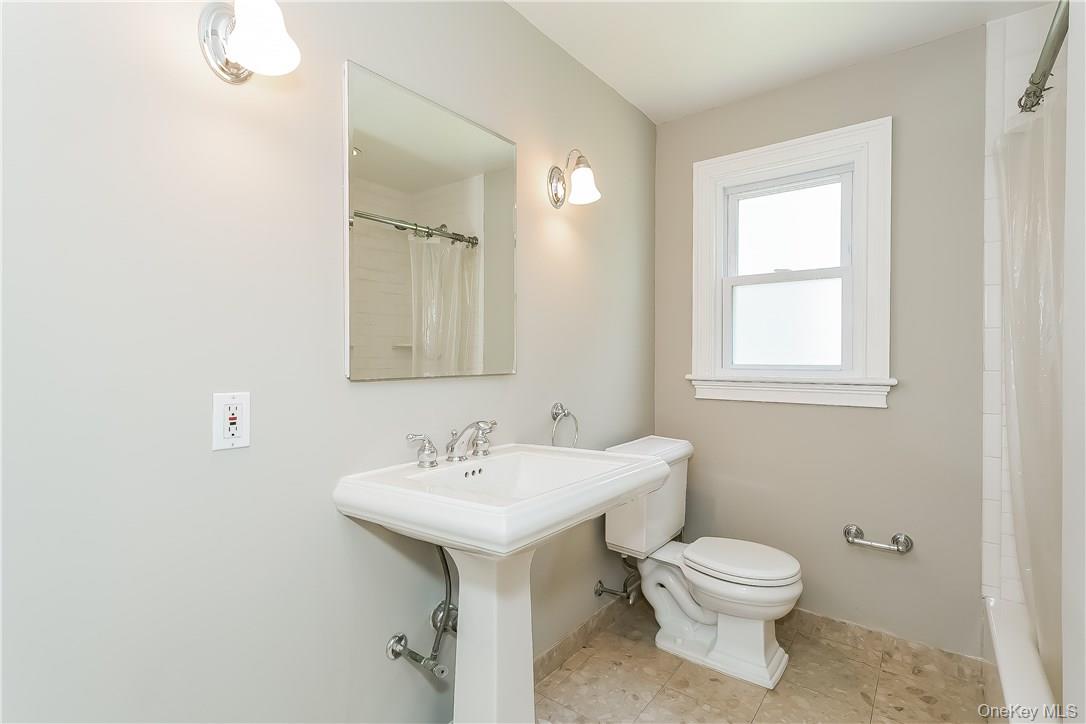 20 Walker Avenue Rye, NY 10580 - Photo 8 of 25 a bathroom with a toilet sink and mirror