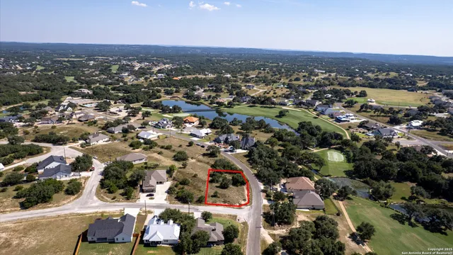 an aerial view of residential houses with city view
