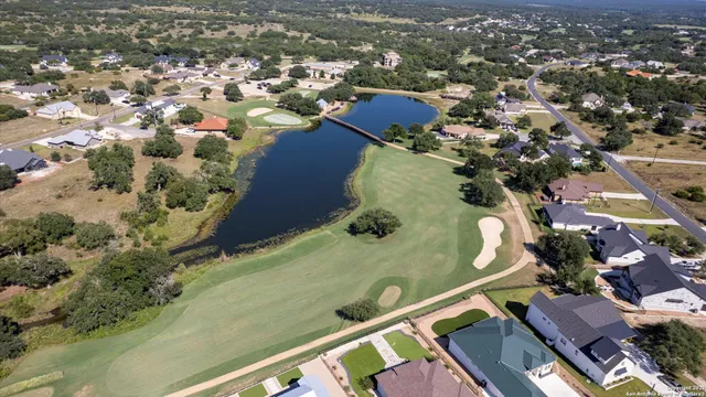 an aerial view of a residential houses with outdoor space