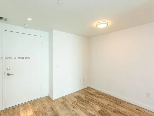 a spacious bathroom with a large mirror vanity and a shower