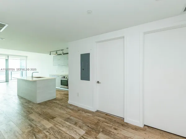 a white toilet sitting next to a white wall