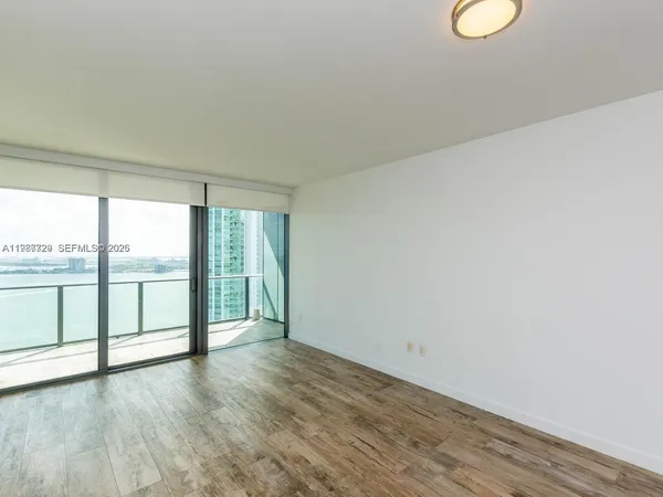a view of a patio with a table and chairs under an umbrella