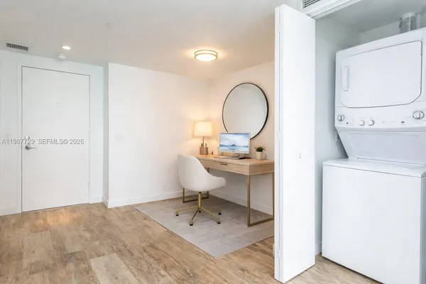 a spacious bedroom with a bed and a flat screen tv