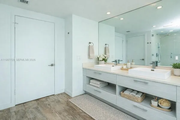 a view of a kitchen with a sink and a refrigerator