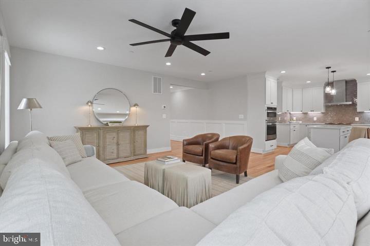 2806 Norbeck Road Silver Spring, MD 20906 - Photo 9 of 41 a living room with furniture kitchen view and a wooden floor