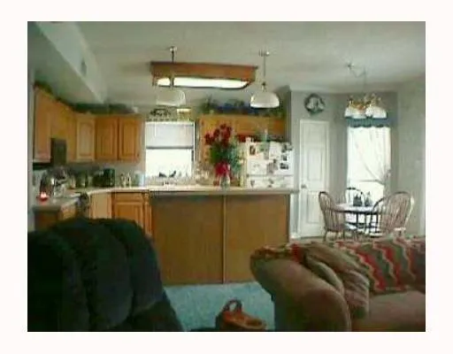 a living room with stainless steel appliances kitchen island granite countertop furniture and a kitchen view