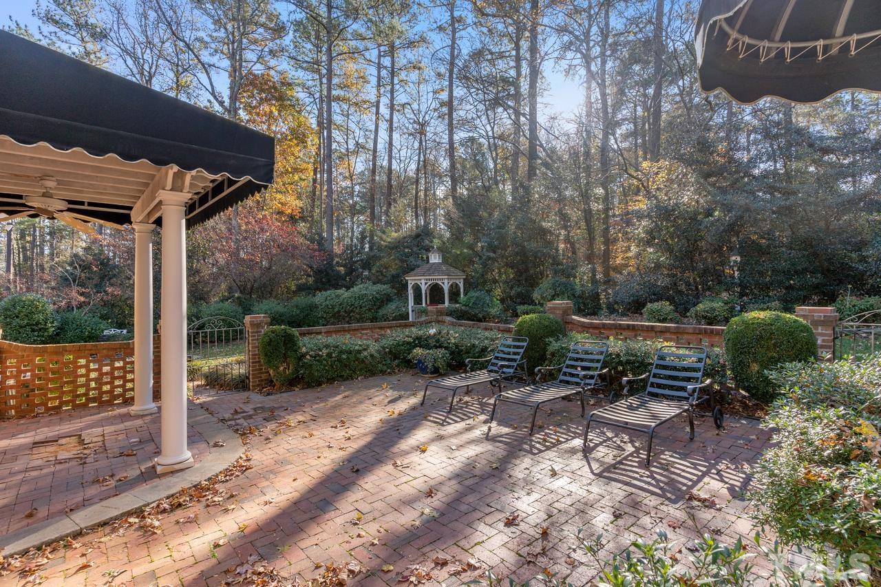 300 Dunstable Court Raleigh, NC 27614 - Photo 5 of 21 a view of a patio with table and chairs and potted plants
