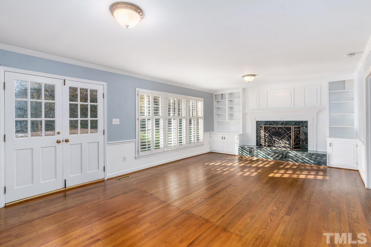 300 Dunstable Court Raleigh, NC 27614 - Photo 8 of 21 an empty room with wooden floor and fireplace