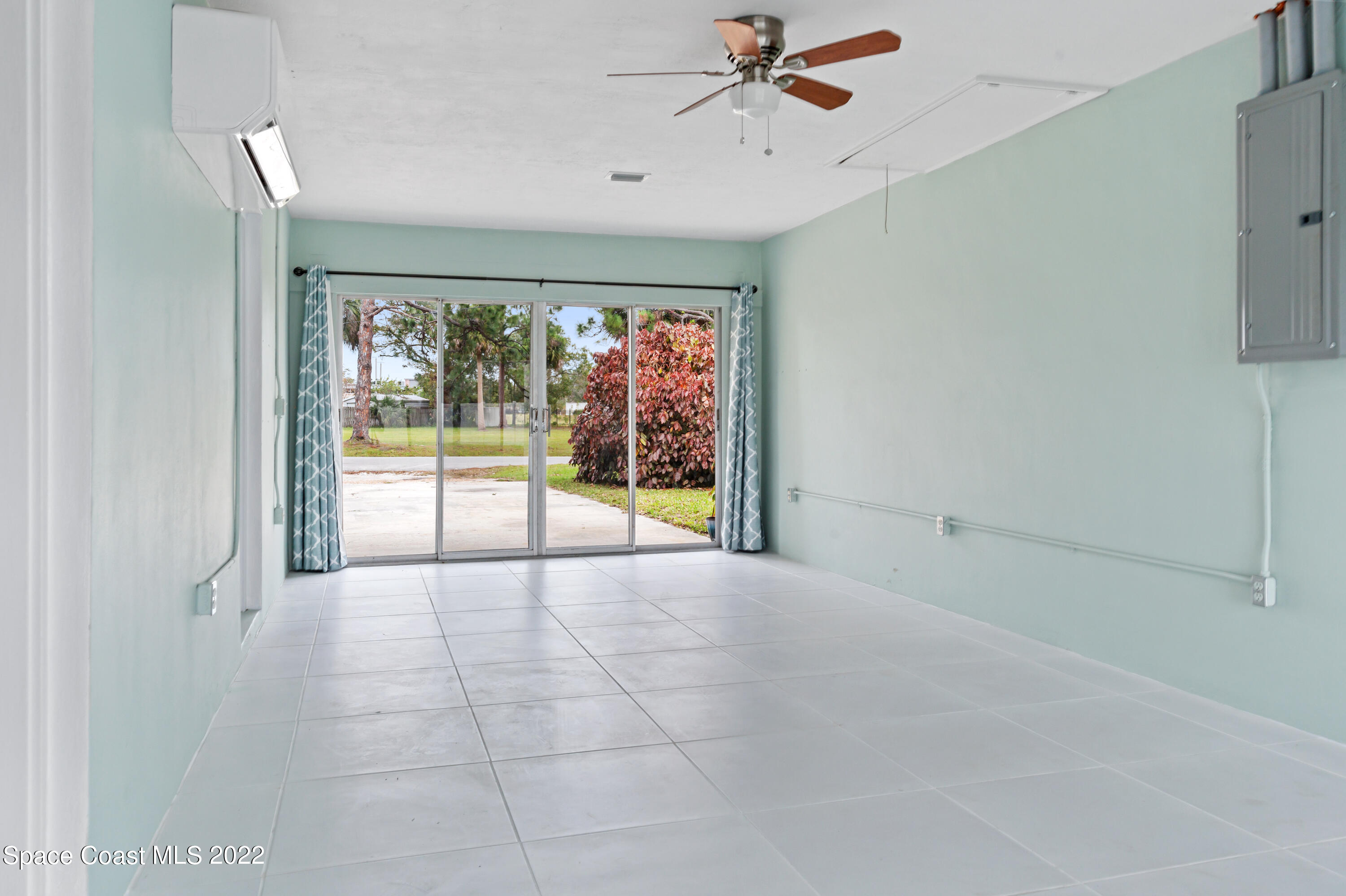 1709 Pinewood Road Melbourne, FL 32934 - Photo 13 of 38 a view of an empty room with a window