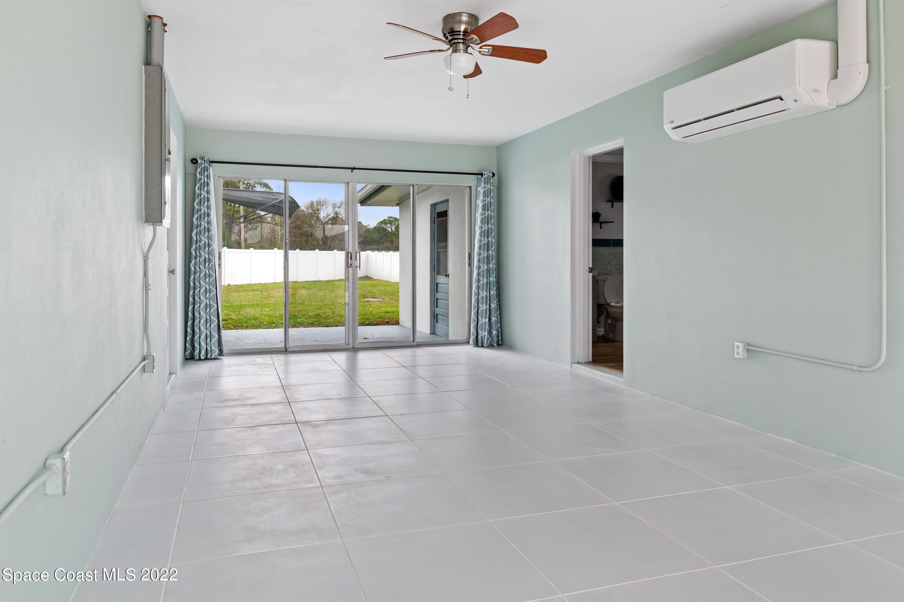 1709 Pinewood Road Melbourne, FL 32934 - Photo 14 of 38 a view of an empty room with a window