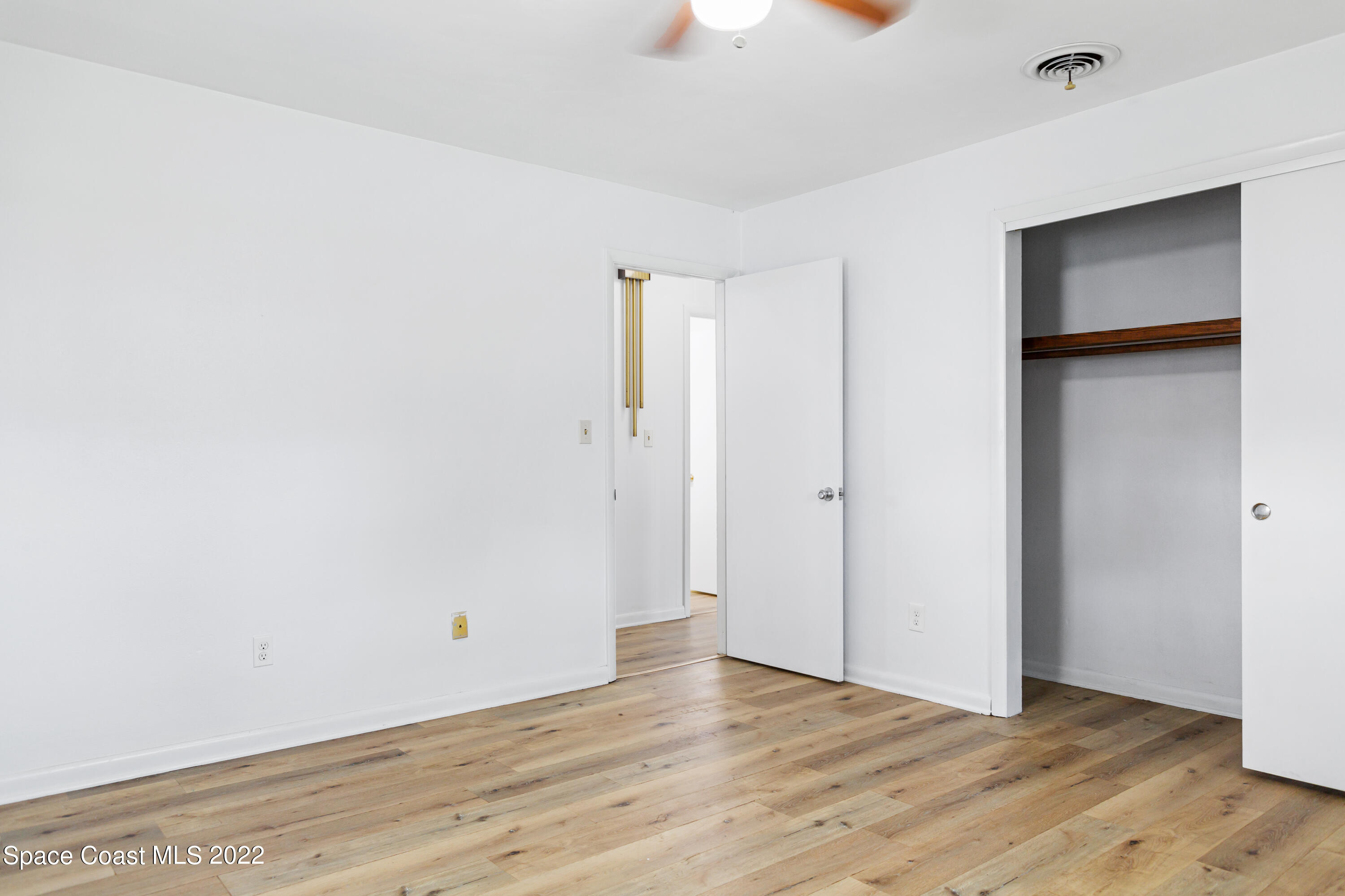 1709 Pinewood Road Melbourne, FL 32934 - Photo 25 of 38 a view of an empty room with wooden floor and a window