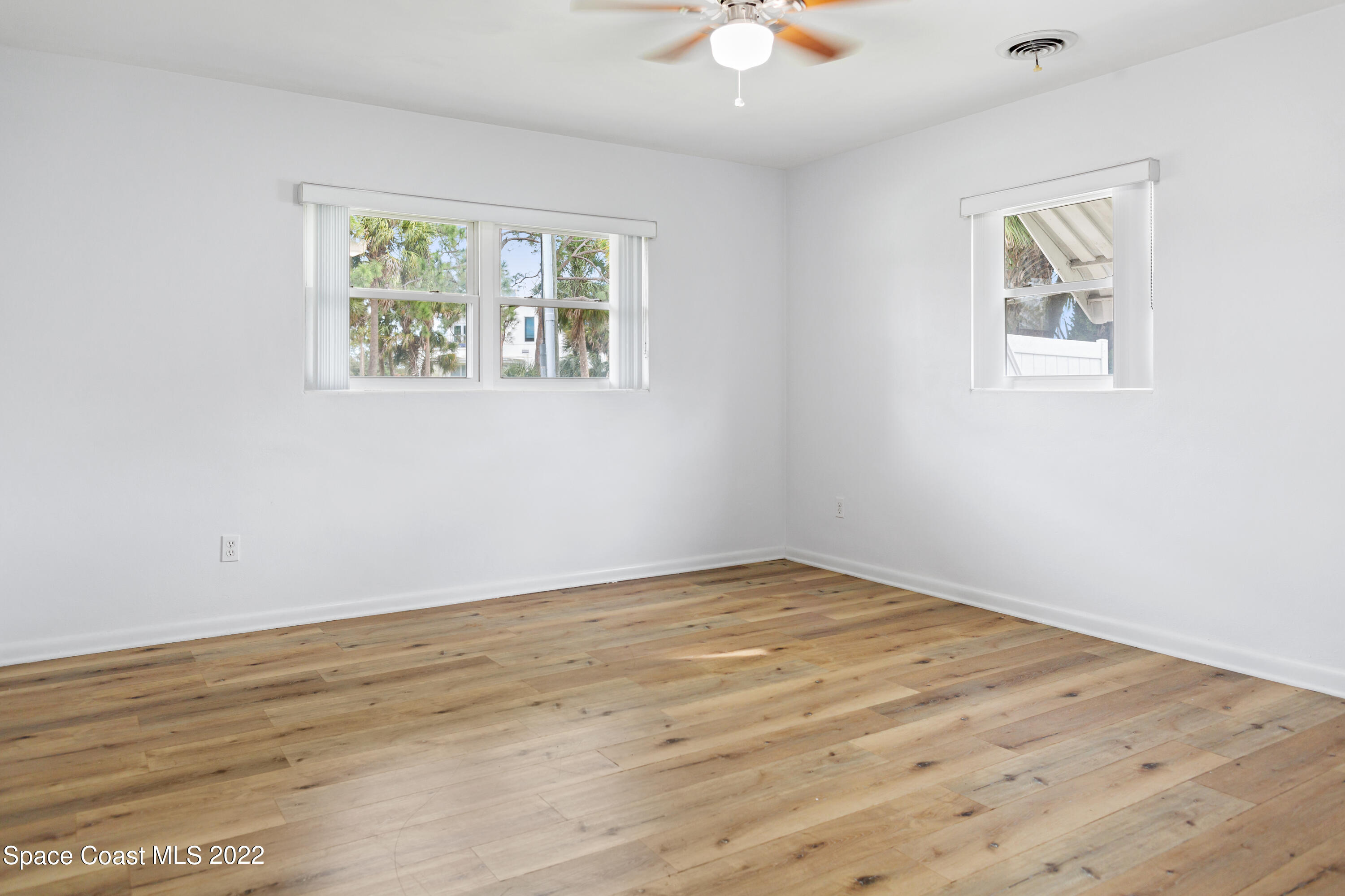 1709 Pinewood Road Melbourne, FL 32934 - Photo 28 of 38 a view of an empty room with a window and wooden floor