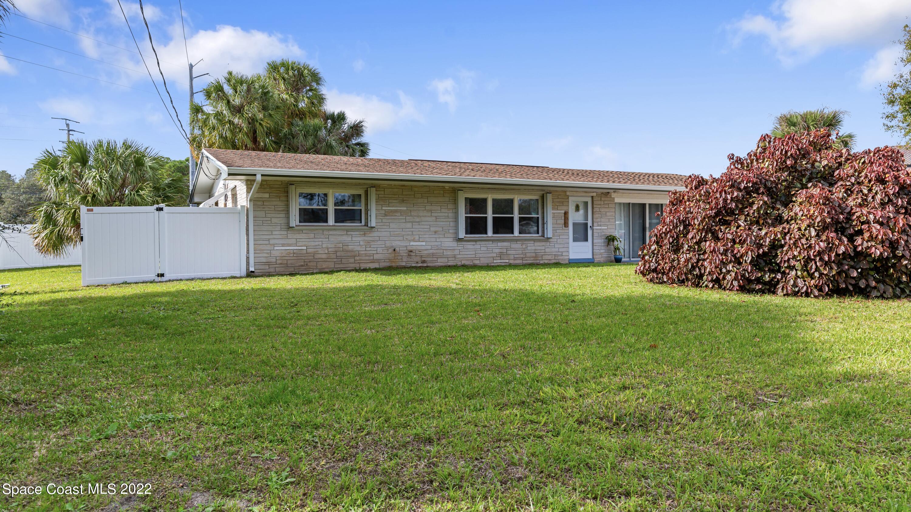 1709 Pinewood Road Melbourne, FL 32934 - Photo 3 of 38 a view of a yard in front of a house with plants and large tree