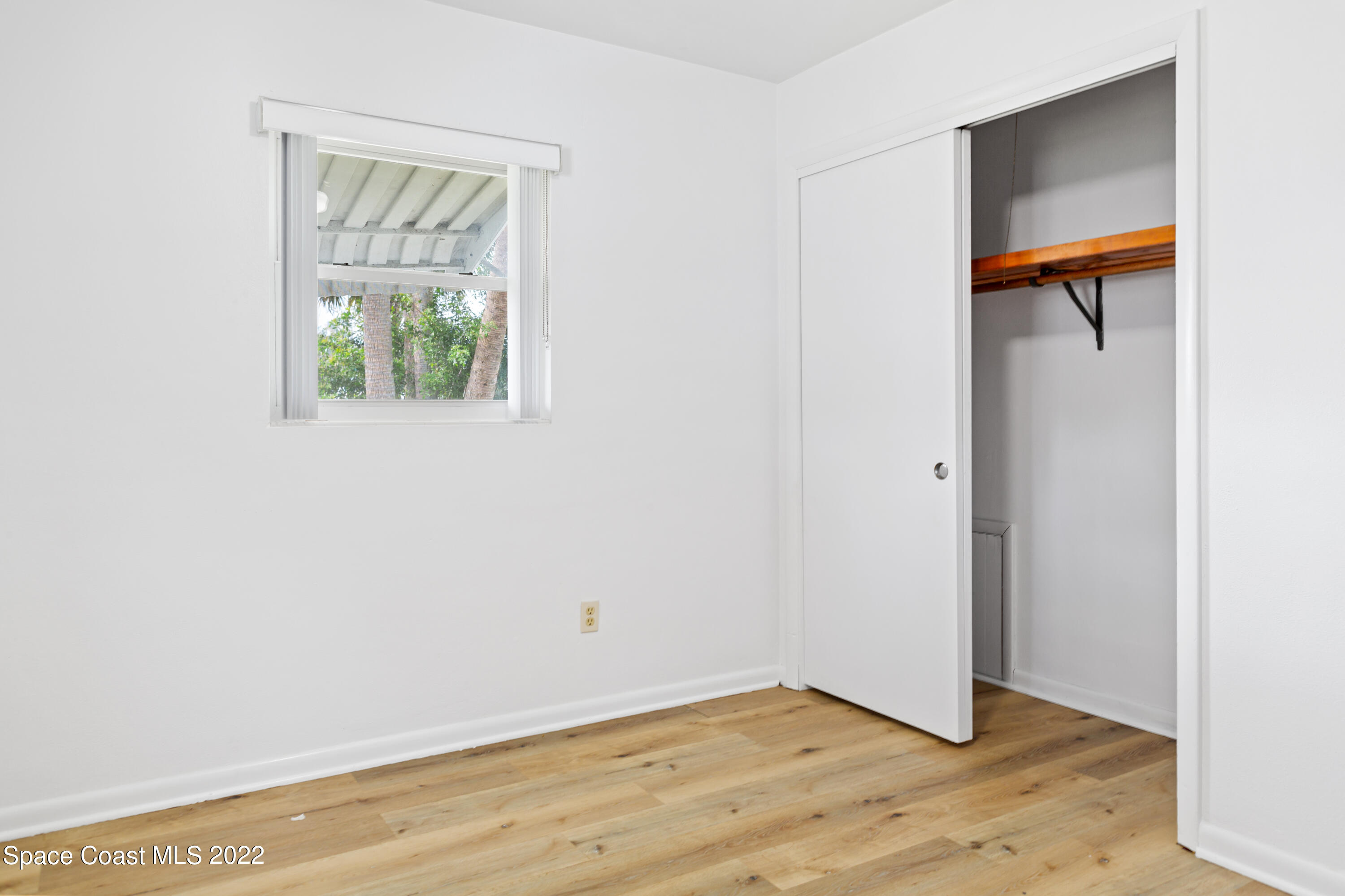 1709 Pinewood Road Melbourne, FL 32934 - Photo 31 of 38 a view of an empty room with wooden floor and a window