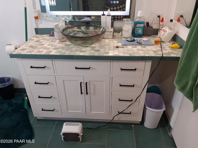 a bathroom with a mirror and a sink