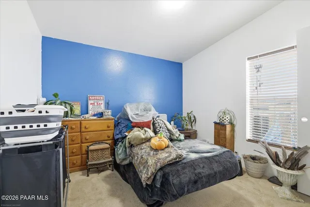 a bed sitting in a bedroom next to a window