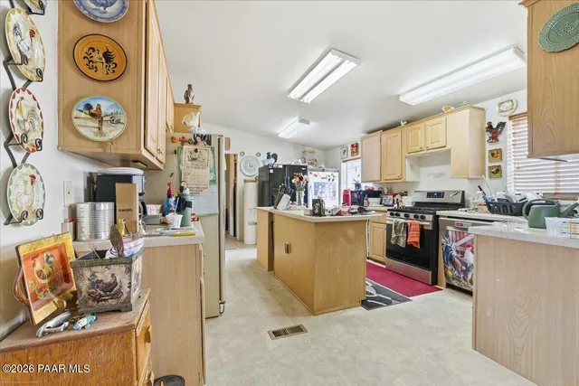 a kitchen with stainless steel appliances granite countertop a stove and cabinets